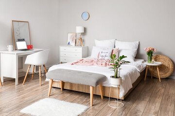 Interior of stylish bedroom with tulip flowers