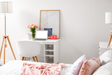 Interior of stylish bedroom with tulip flowers