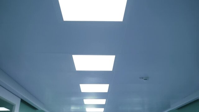 Ceiling with white square lamps in hospital corridor