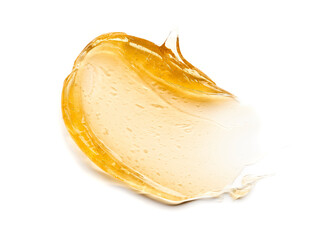 Transparent yellow smear of face cream or golden honey isolated on white background. Golden creamy...