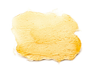 Transparent yellow smear of face cream or golden honey isolated on white background. Golden creamy texture on white background.