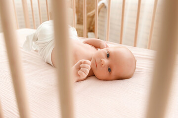 newborn baby lies in the crib