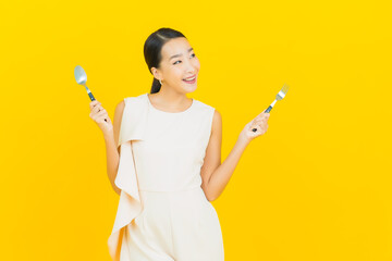 Portrait beautiful young asian woman smile with spoon and fork