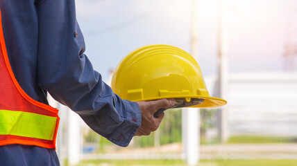Close up project engineer holding helmet hard hat construction building