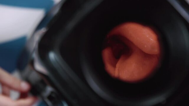 Blender close up, press button to start mixing summer cool strawberry smoothie