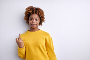 Portrait of confident afro american woman making fuck you sign. Naughty concept. Fuck off. Isolated...