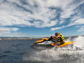  jet ski watercraft group cruising in high speed in the sea of a beach in Mallorca