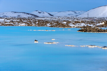 Unique landscape with lava fields and blue thermal water in Iceland. Outside Blue Lagoon in Iceland. The blue water between the lava stones. Hot springs Blue Lagoon in Iceland.