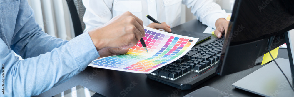 Aufkleber graphic designer or creative working together coloring using graphics tablet and a stylus at desk wi