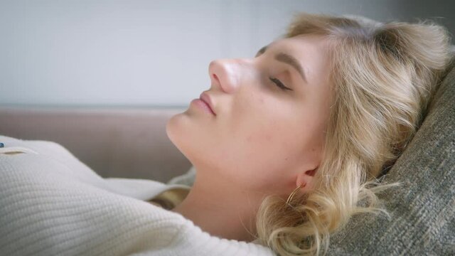 Face of a young patient lying on a couch with closed eyes on meditation