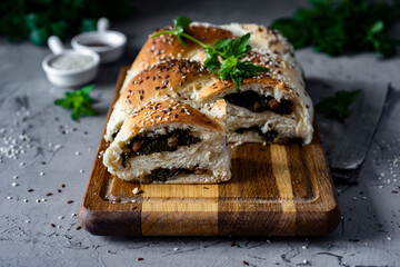 Delicious breakfast: yeast pie with sorrel and raisins on a gray table. Close-up