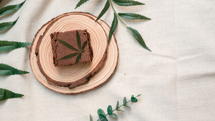 cannabis brownie on wooden plate