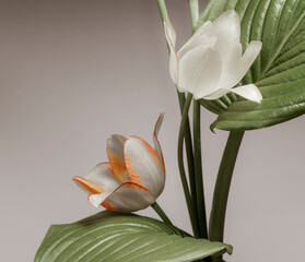 flowers with petals like lilies and tropical foliage, oriental composition on a beige background.