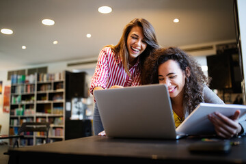 Group of college students studying in the school library