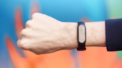 A male hand with fitness bracelet
