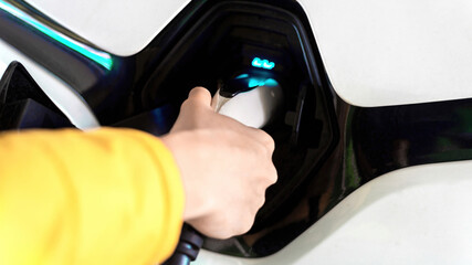 Plugging in charger into an electric car