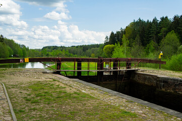 Old navigable river sluice. 20th century architecture with wooden mechanics. Augustow Canal,...