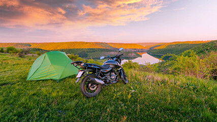 Motorcycle traveling concept, camping with a tent, scenic nature landscape with canyon in the...