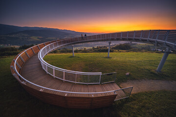 Picturesque sunset in Beskid Sądecki seen from the tower in Wola Krogulecka, with views of the mountains and fields. - obrazy, fototapety, plakaty