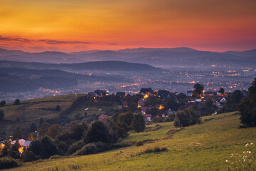 Picturesque sunset in Beskid Sądecki seen from the tower in Wola Krogulecka, with views of the mountains and fields. © PawelUchorczak