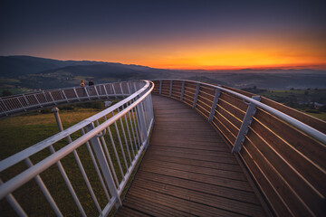 Picturesque sunset in Beskid Sądecki seen from the tower in Wola Krogulecka, with views of the mountains and fields. © PawelUchorczak