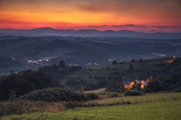 Picturesque sunset in Beskid Sądecki seen from the tower in Wola Krogulecka, with views of the mountains and fields. © PawelUchorczak