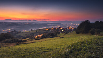 Picturesque sunset in Beskid Sądecki seen from the tower in Wola Krogulecka, with views of the mountains and fields. © PawelUchorczak