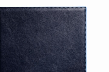 Black fine texture of genuine leather. Close-up edge. Blue threds