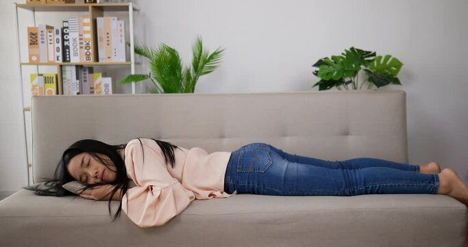 woman laying down sofa to sleep