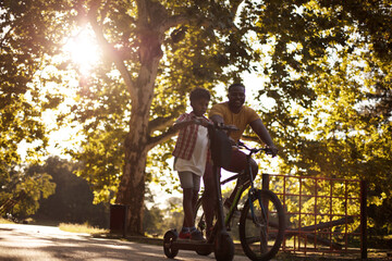  Recreate day.  African American father having fun outdoors with his son.