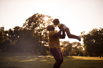 Fototapeta na wymiar African American father and daughter having fun outdoors.