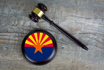 Wooden judgement or auction mallet with of Arizona flag. Conceptual image.