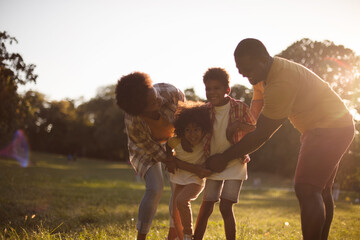 Fototapeta premium African American family having fun outdoors.