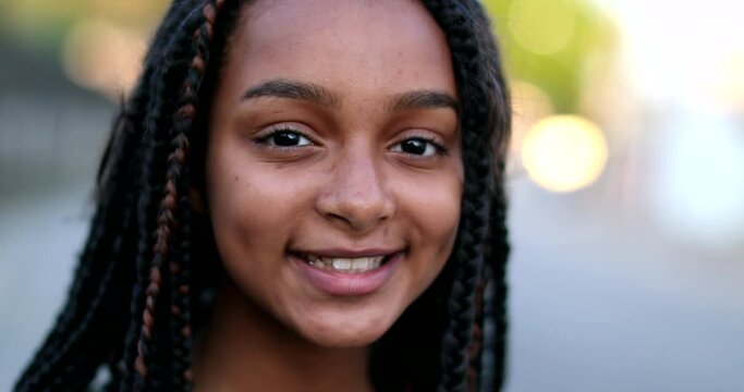 Hispanic black preteen girl face smiling. Brazilian happy child