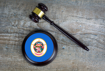 Wooden judgement or auction mallet with of Minnesota flag. Conceptual image.