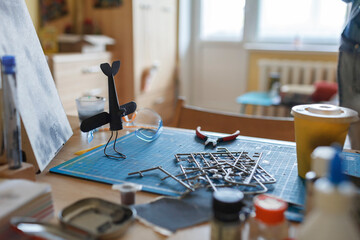 A workplace of geek teenage girl engineering an airplane model at home, generation Z lifestyle,...