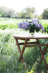 bouquet of lilacs on the table in the summer garden
