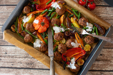 Meatballs with vegetables. Delicious and healthy oven dish with dip sauce