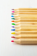 Obraz premium Pastel tips of various colors, on a light wooden surface. Design and colors. 