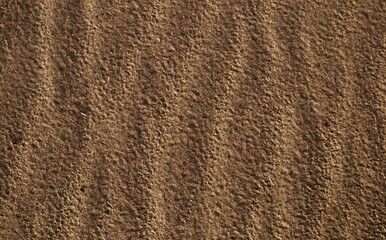 Sand on the beach and wave tracks on the sand