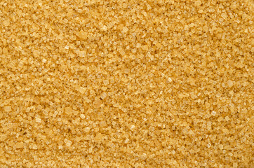Brown demerara sugar, background, from above. Coarse, crystalline, natural and raw sugar, a sucrose...