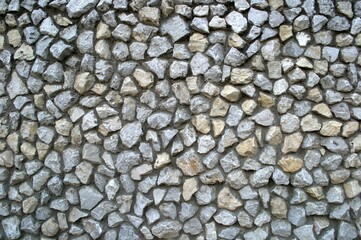 A wall of stones. The stones are carefully laid out in a mosaic.