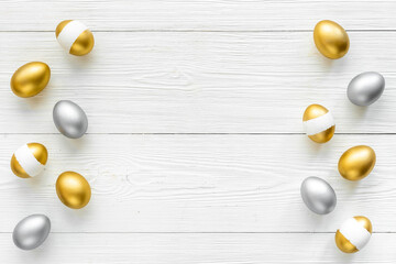 Flat lay of golden and silver eggs. Good luck symbol. Easter decoration