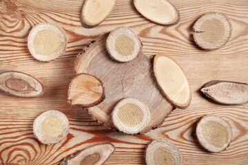 Slices of a tree on wooden background.