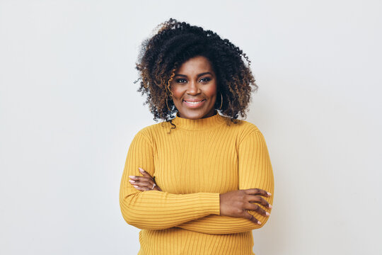 Portrait of smiling beautiful African American woman standing with arms crossed
