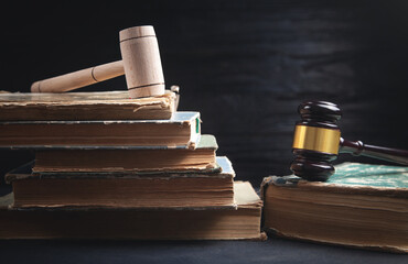 Judge gavel and book on the black background.