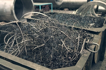 Metal shavings or scrap metal waste steel for recycling in container in factory.