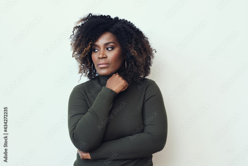 Wall mural thoughtful african american woman looking away at copy space with hand on chin