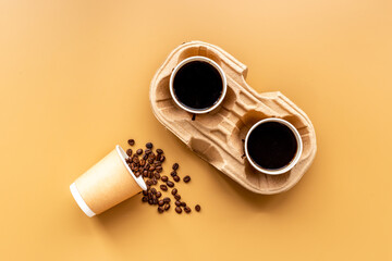 Flat lay of black coffee in paper cups with beans