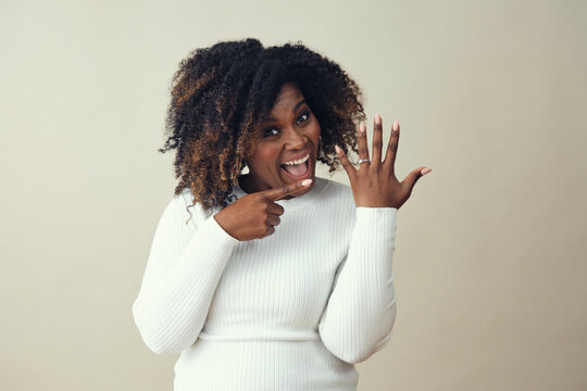 Ecstatic Black African American Woman Pointing At Engagement Ring